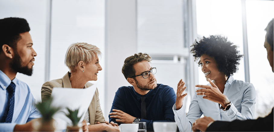 Colleagues discussing at a business meeting table.