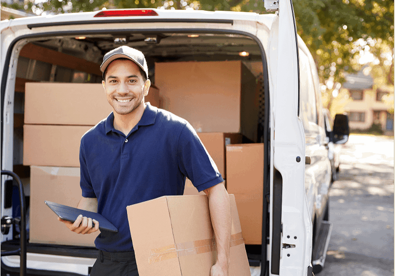 Delivery person with packages near van.